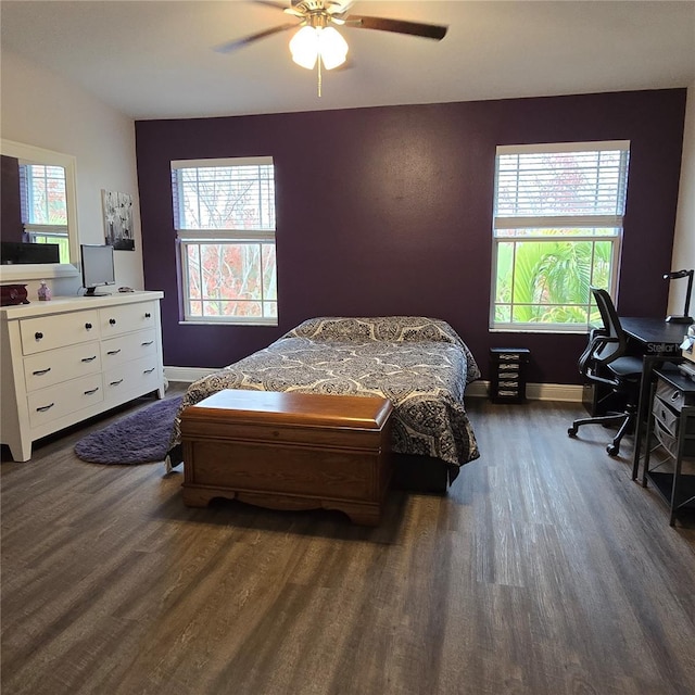 bedroom with ceiling fan and dark hardwood / wood-style flooring