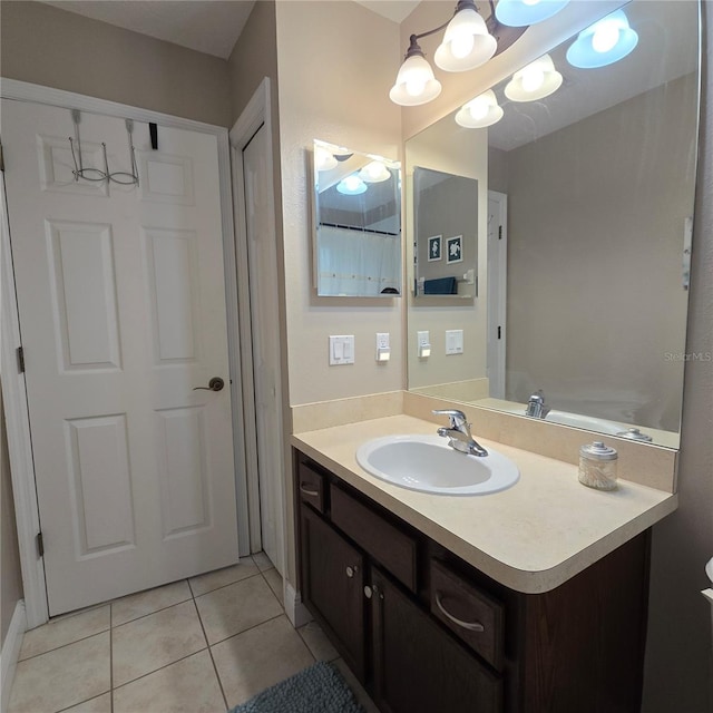 bathroom featuring vanity, tile patterned flooring, and an inviting chandelier