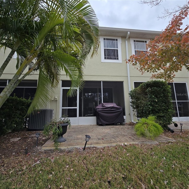 back of house with a sunroom and a patio area