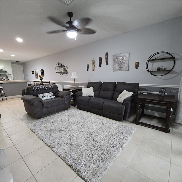 tiled living room featuring ceiling fan