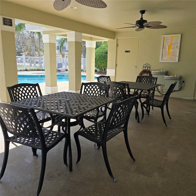 view of patio / terrace featuring ceiling fan and a fenced in pool