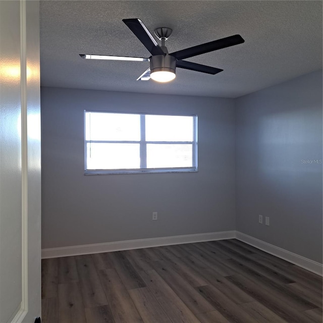 unfurnished room with a textured ceiling, ceiling fan, and dark wood-type flooring