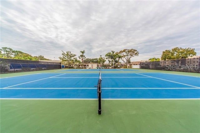 view of tennis court featuring basketball hoop