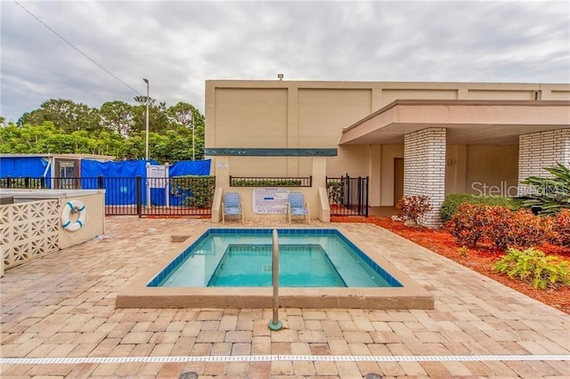 view of pool with a community hot tub