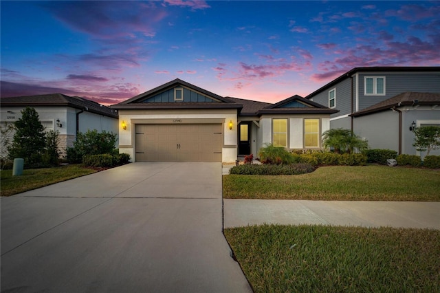 view of front facade featuring a garage and a lawn