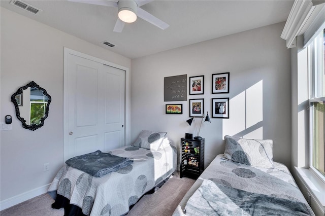 carpeted bedroom with a closet and ceiling fan