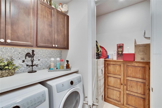 clothes washing area featuring cabinets and independent washer and dryer