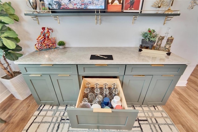 kitchen with light stone counters and light wood-type flooring