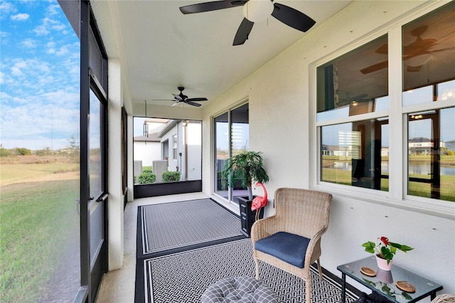 sunroom / solarium featuring ceiling fan