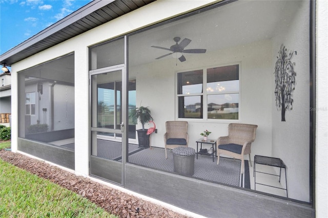 view of patio / terrace featuring a sunroom and ceiling fan