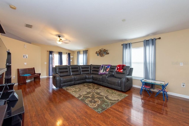 living room with dark hardwood / wood-style flooring, ceiling fan, and lofted ceiling