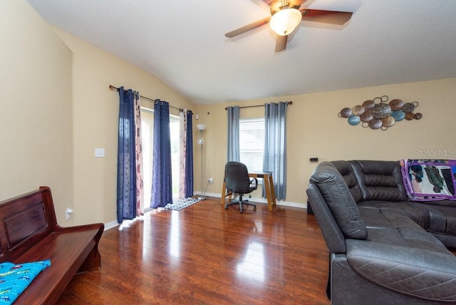 living room featuring ceiling fan, lofted ceiling, and dark wood-type flooring