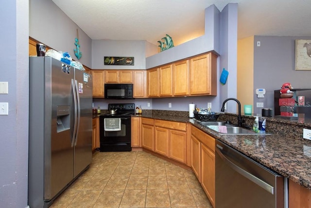 kitchen with kitchen peninsula, sink, black appliances, light tile patterned floors, and dark stone countertops