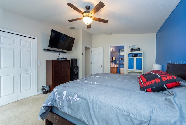 carpeted bedroom with ceiling fan, lofted ceiling, and a closet