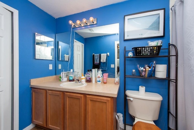 bathroom with vanity and toilet