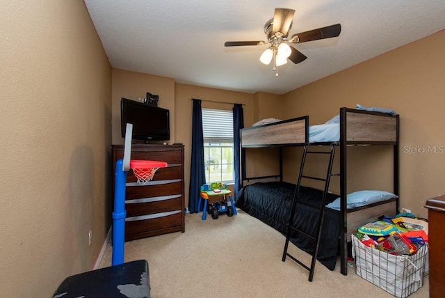 bedroom featuring ceiling fan and light colored carpet