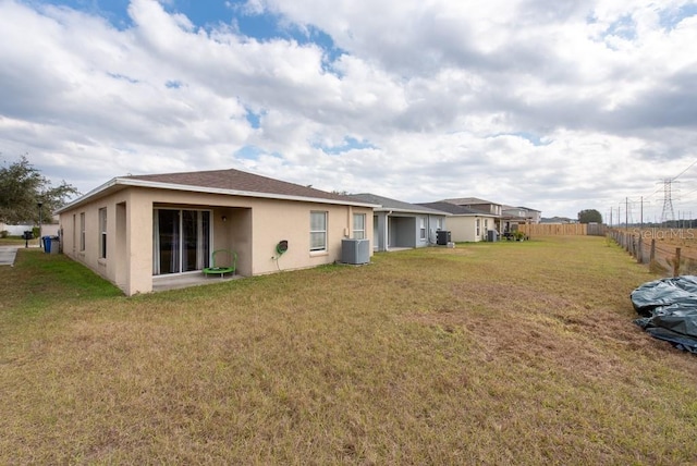 exterior space with a lawn and central AC unit