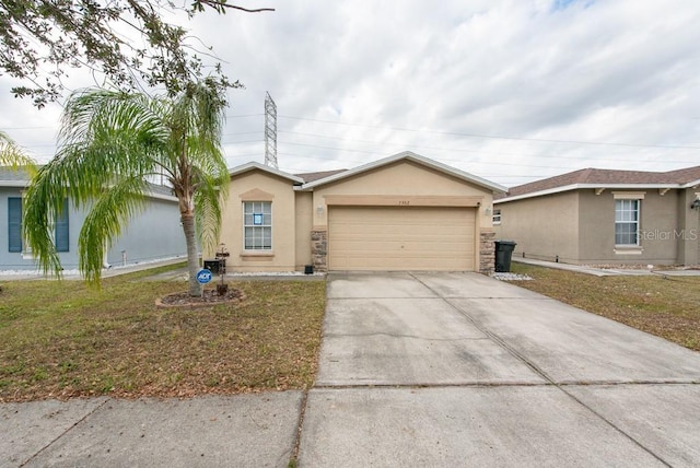 single story home with a garage and a front lawn