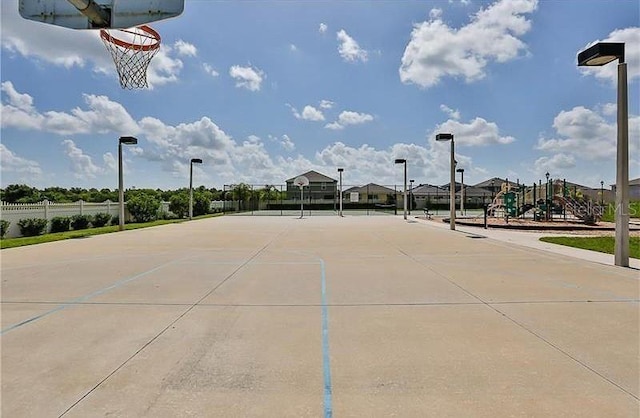 view of basketball court with a playground