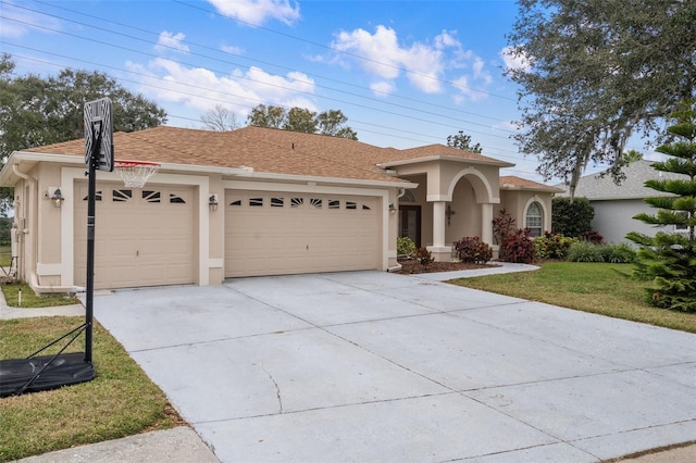 view of front of home with a garage and a front lawn