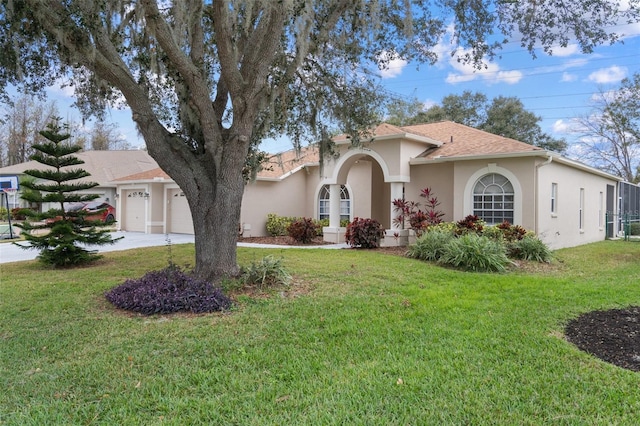 view of front of home with a front lawn and a garage