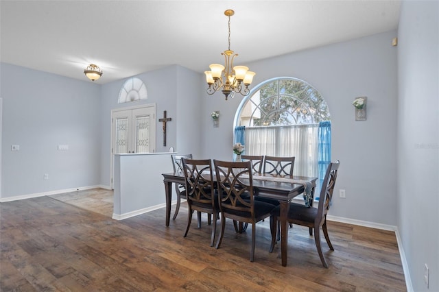 dining space with a chandelier and dark hardwood / wood-style flooring