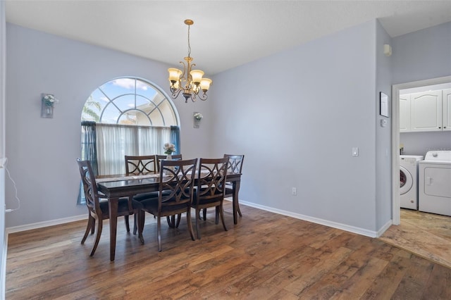 dining area featuring a chandelier, dark hardwood / wood-style flooring, and washer and clothes dryer