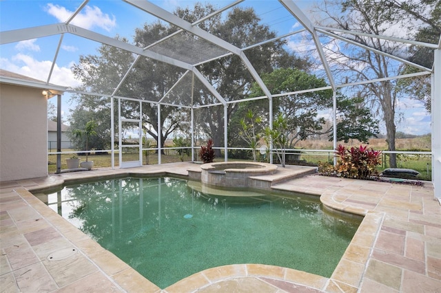 view of swimming pool featuring a patio area, a lanai, and an in ground hot tub