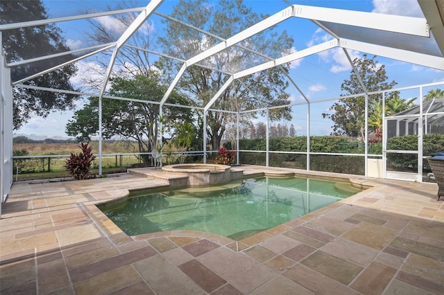 view of swimming pool with a patio area, a lanai, and an in ground hot tub