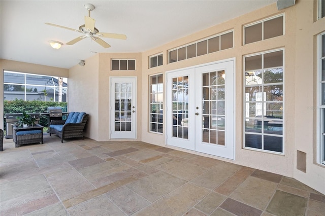 interior space with ceiling fan, plenty of natural light, and french doors