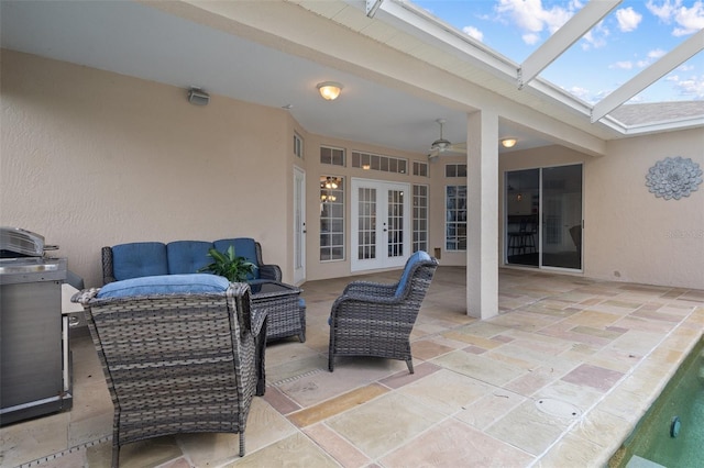 view of patio / terrace with outdoor lounge area, ceiling fan, glass enclosure, and french doors