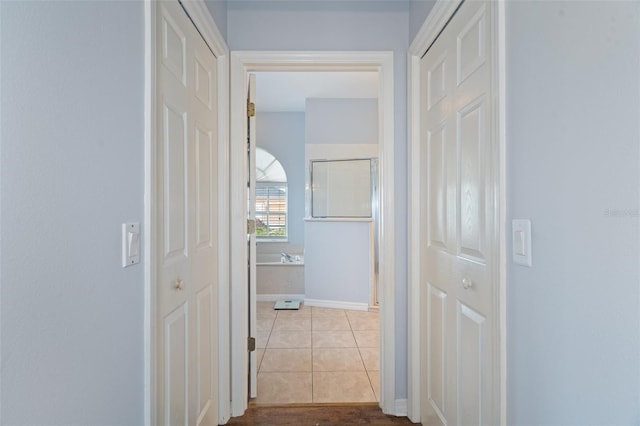 hall with light tile patterned floors