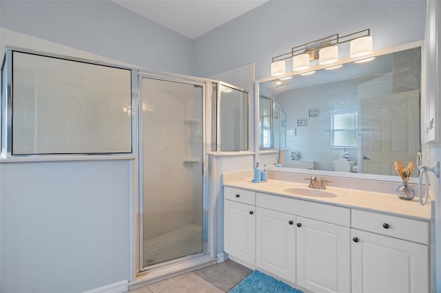 bathroom featuring vanity, tile patterned floors, and a shower with shower door