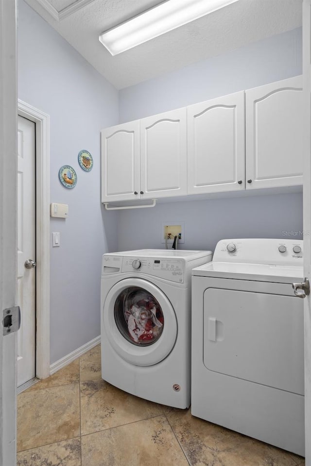 laundry area with cabinets and washing machine and clothes dryer