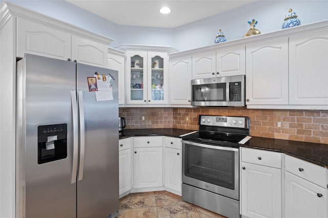 kitchen featuring backsplash, white cabinetry, and stainless steel appliances