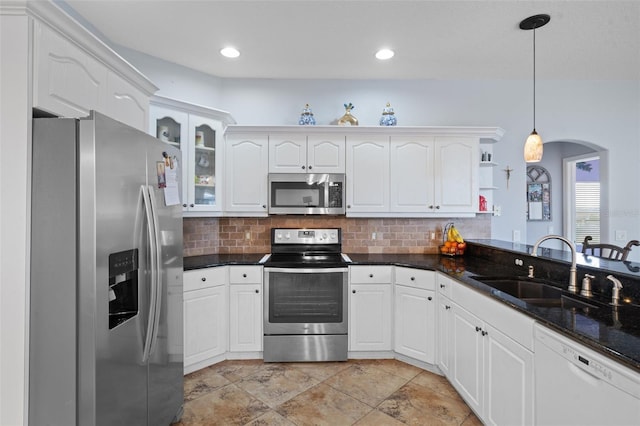 kitchen with white cabinetry, sink, hanging light fixtures, kitchen peninsula, and appliances with stainless steel finishes