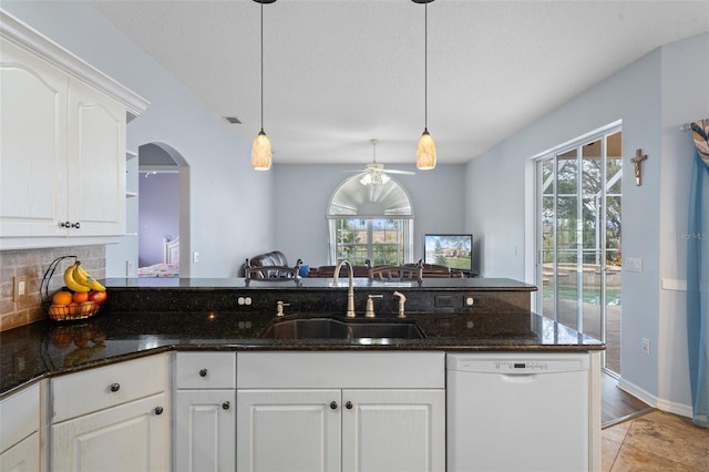 kitchen featuring dishwasher, sink, a healthy amount of sunlight, hanging light fixtures, and white cabinets