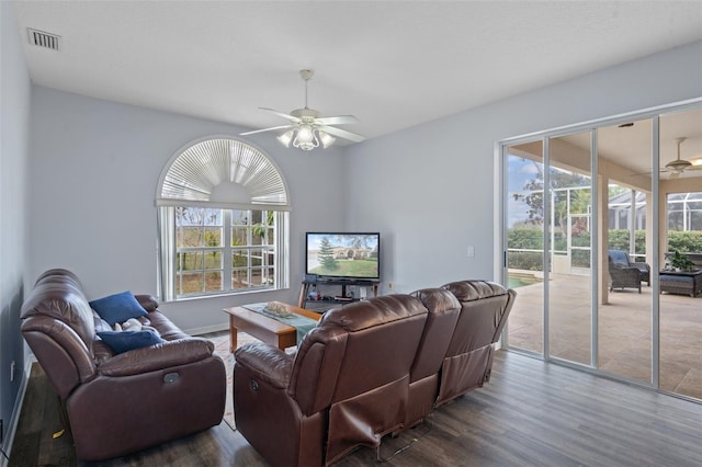 living room with hardwood / wood-style flooring, ceiling fan, and a healthy amount of sunlight