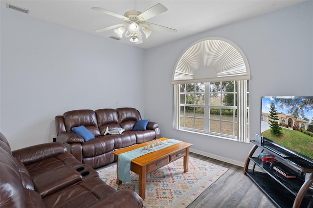 living room featuring hardwood / wood-style flooring and ceiling fan