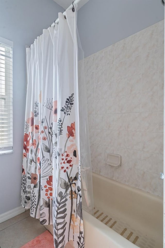 bathroom featuring tile patterned flooring and shower / bath combination with curtain