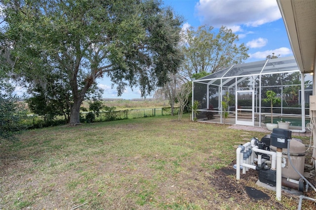 view of yard featuring a pool and glass enclosure