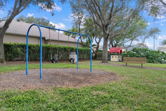 view of jungle gym featuring a lawn