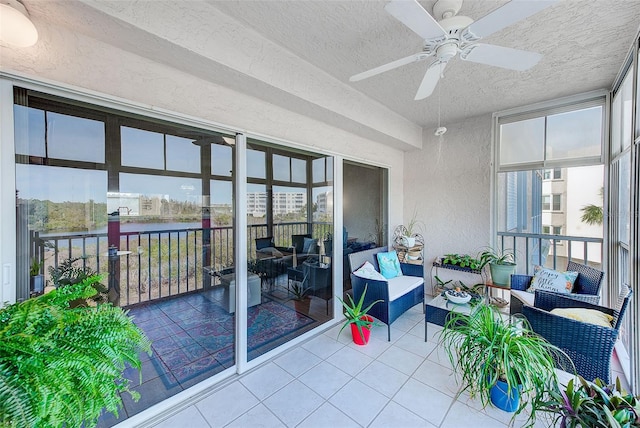 sunroom / solarium featuring ceiling fan