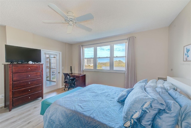 bedroom featuring access to outside, ceiling fan, a textured ceiling, and light hardwood / wood-style flooring