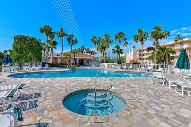 view of swimming pool featuring a community hot tub and a patio