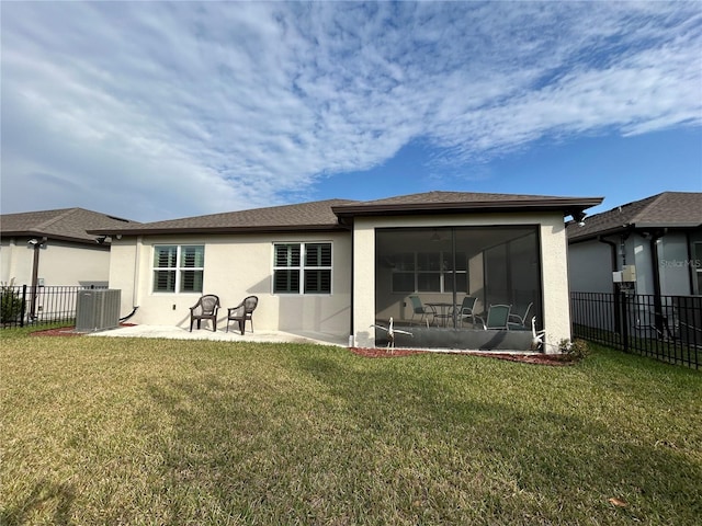 back of property with a patio, central AC, a lawn, and a sunroom