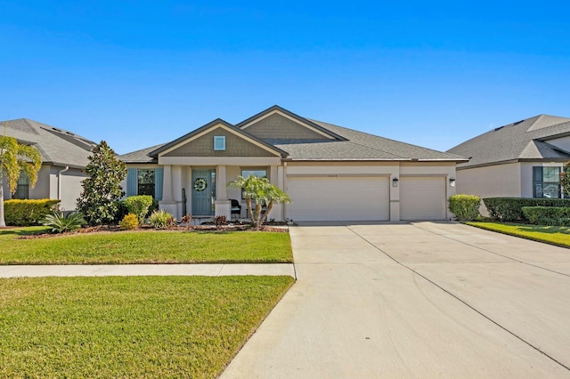 view of front of house featuring a garage and a front lawn