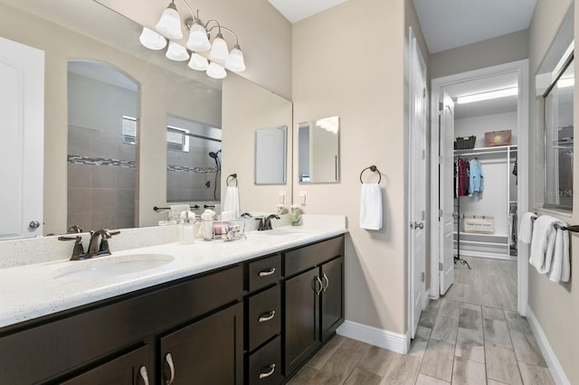 bathroom with vanity and tiled shower