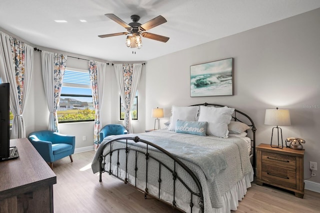 bedroom with ceiling fan and light hardwood / wood-style floors