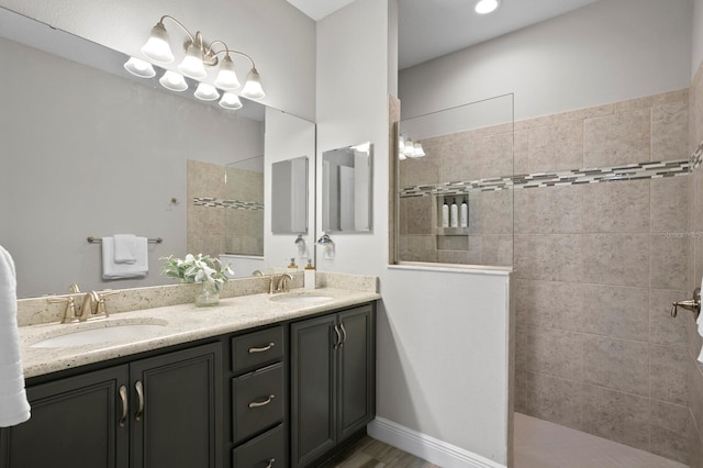 bathroom with vanity and tiled shower